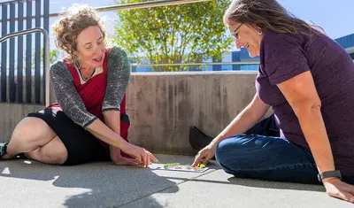 Enid Baxter Ryce, left, works with a participant in the ESTA program.