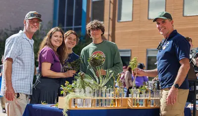 Professor Fred Watson, right, discusses environmental science with visitors at CSUMB's annual Open House.