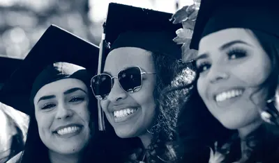 Graduates smiling during commencement