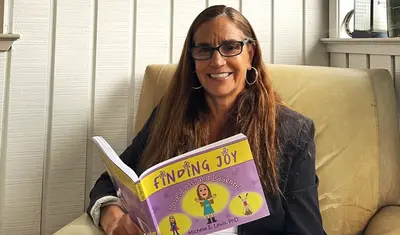 Michelle Lewis with book 