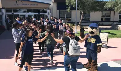 Photo: New students being greeted on their way to the University Center