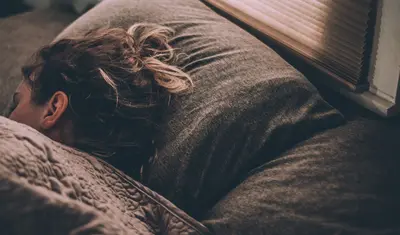 A woman sleeping | photo by Gregory Pappas