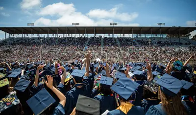Graduating students wave to their families during the 2023 Commencement at the Salinas Sports Complex. | Photo by Brent Dundore-Arias