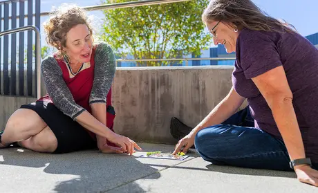 Enid Baxter Ryce, left, works with a participant in the ESTA program.